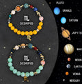 Two natural stone beaded bracelets with zodiac charms on an elastic string, showing the adjustable fit.