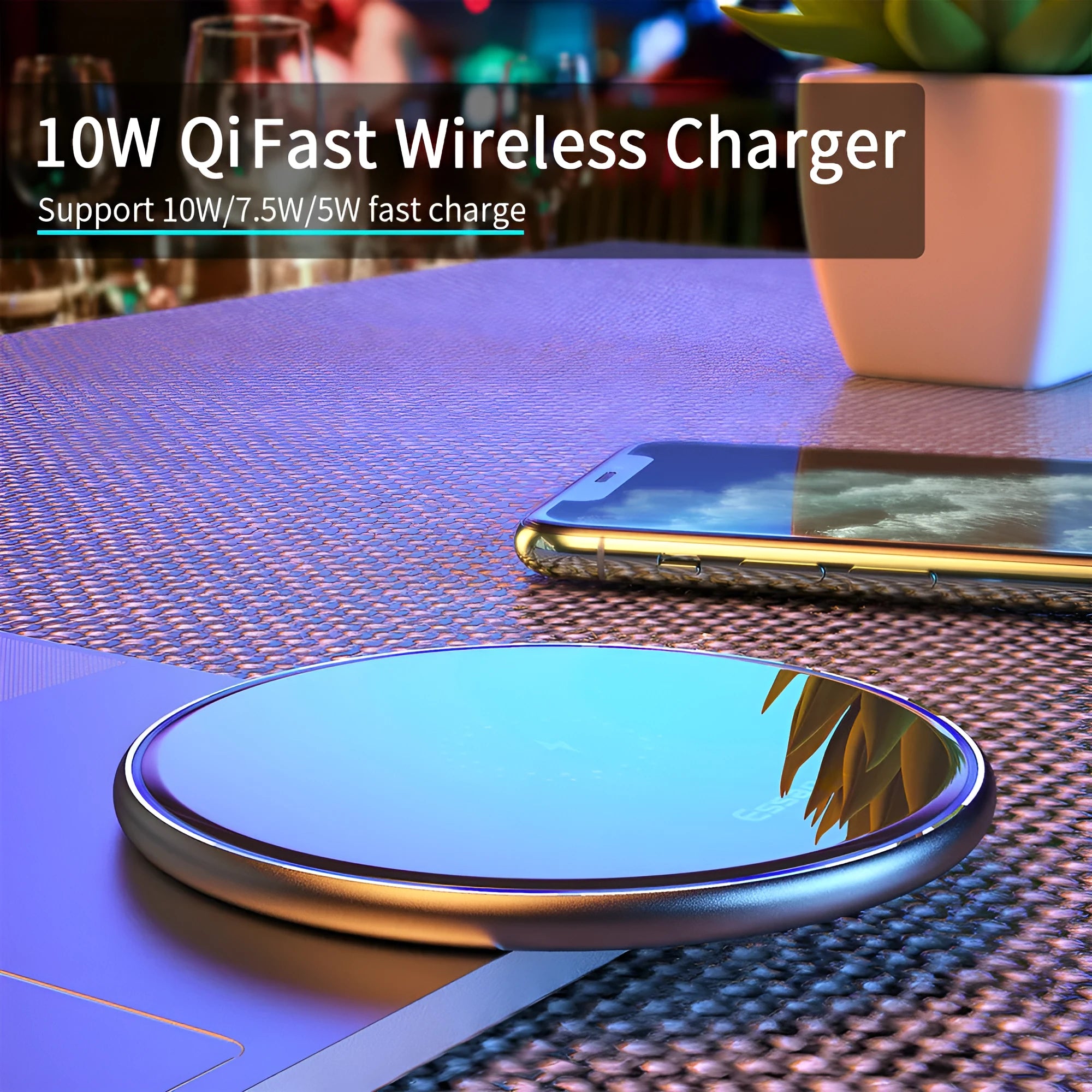 Black aluminium 15W Qi wireless fast charger for phones on a wooden desk.