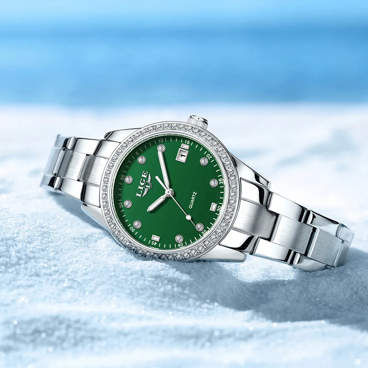 Women's silver stainless steel quartz watch with diamond dial and luminous hands on wrist.