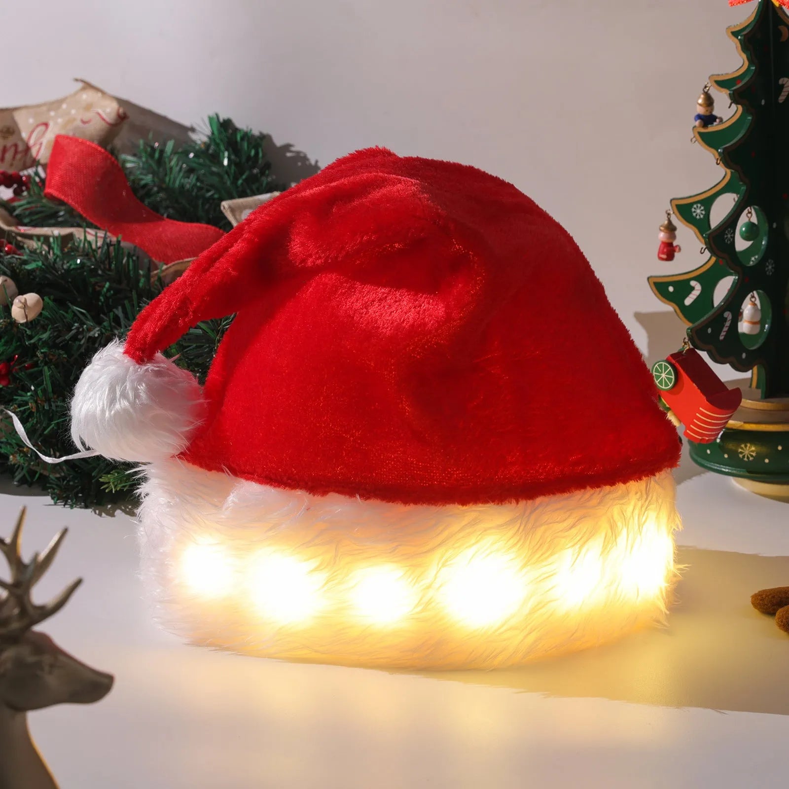 Red and white plush Santa Christmas hat with LED lights glowing, showing pom-pom and stretchy spandex material.