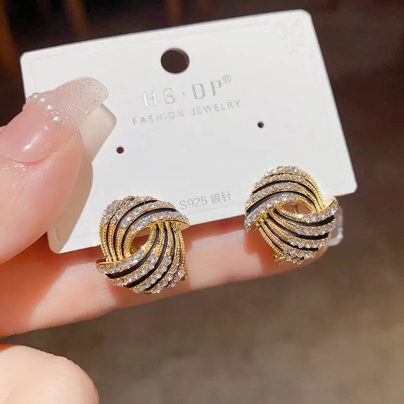 Gold plated rhinestone stud earrings with geometric ring shape and super-flash finish