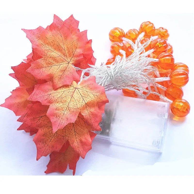Halloween pumpkin and maple leaf LED light string on a dark background, with warm white 3000K glow