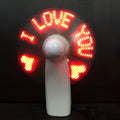 White handheld mini fan with flashing blue and red LED 'I Love You' text on a clear display panel.