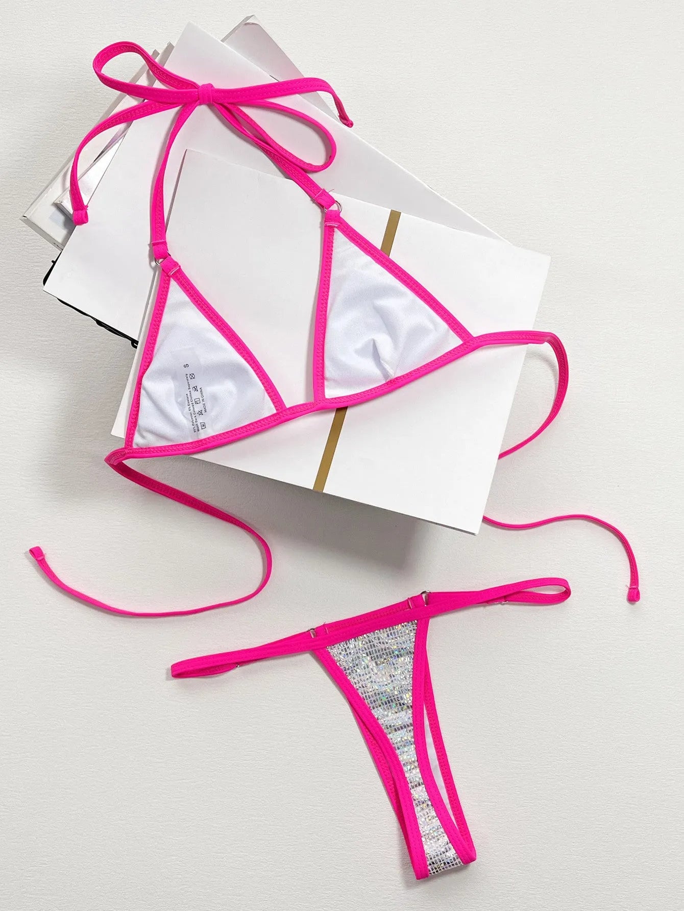 Silver women's split triangle bikini top on a white background.