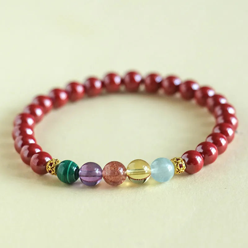 Purple gold cinnabar crystal bead bracelet on wrist showing handcrafted string construction