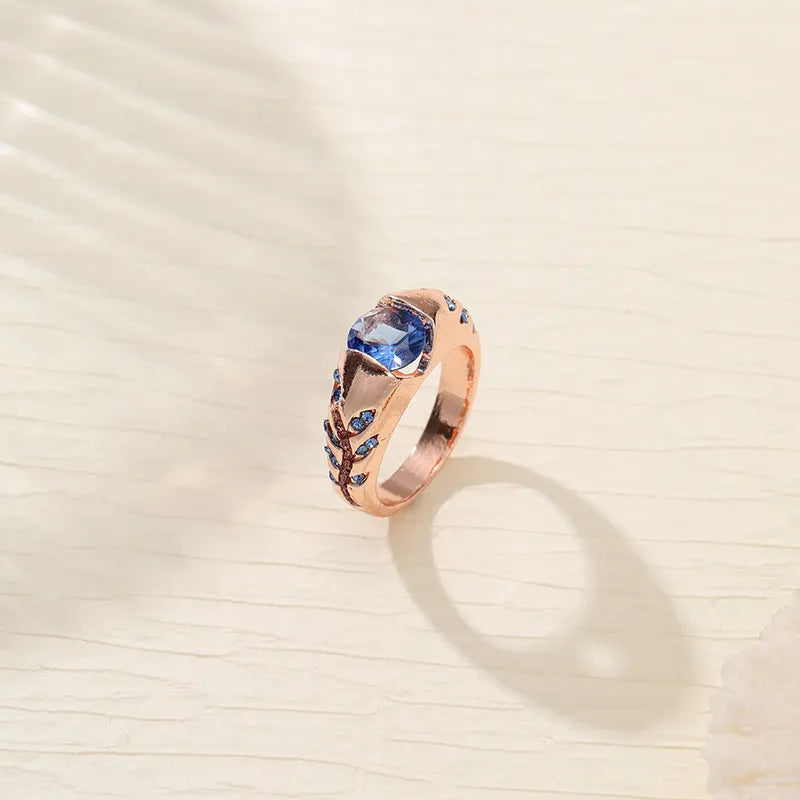 Leaf style zinc alloy ring with round zirconium inlay in gold colour on white background