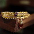 Natural Brazil gold rutilated quartz bracelet with Chinese style design and three gold rings