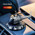 Silver metal solar helicopter car perfume ornament with rotating blades on a dashboard.