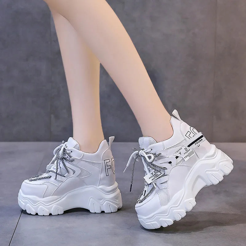 Women's white mesh platform sports shoes with cross strap and round toe on a rubber sole.