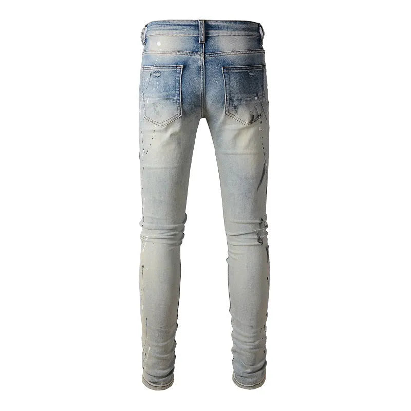 Men's blue light coloured paint splashing ink making old washed denim jeans with small straight leg and zip fly