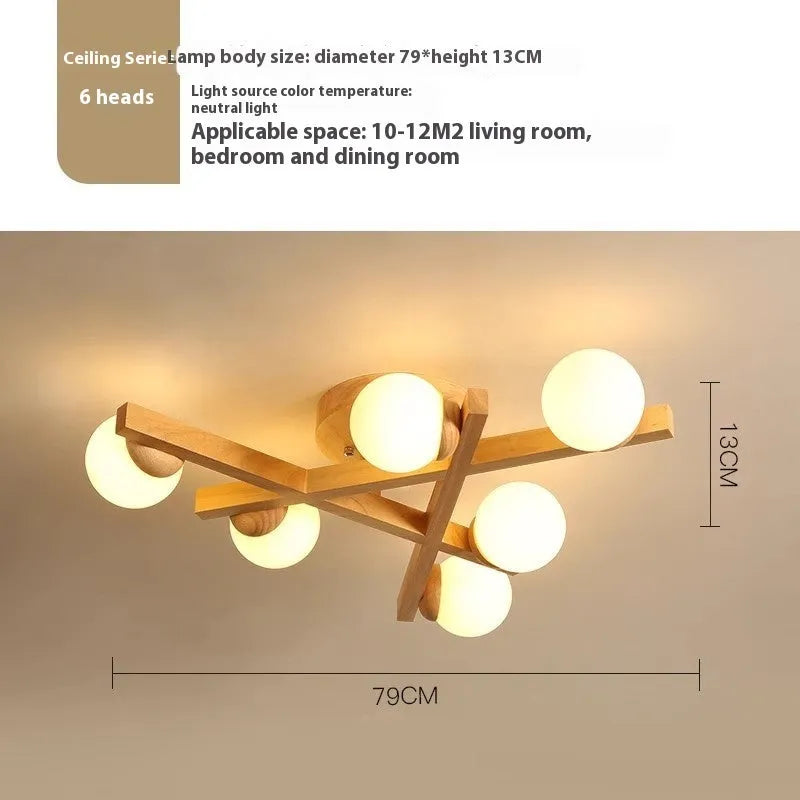 Modern Nordic-style wooden ceiling light fixture with three adjustable lamp heads mounted on a living room ceiling.