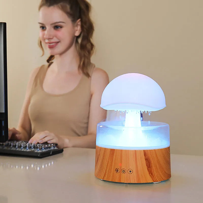 White cloud-shaped humidifier and aroma diffuser with falling water droplets and coloured lights