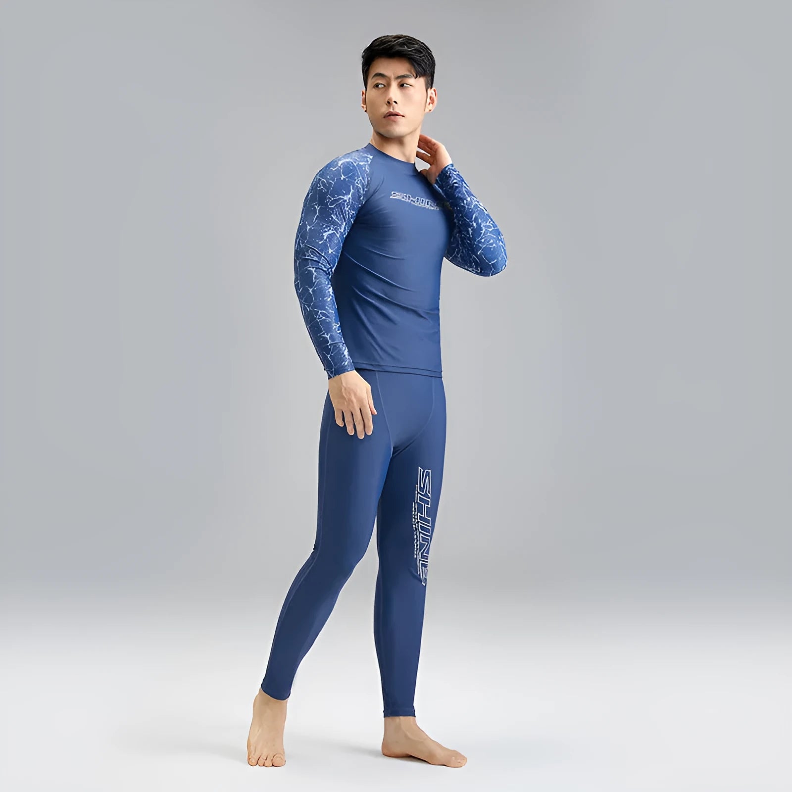 Men's dark blue patterned nylon swimwear set with top and shorts on size chart.