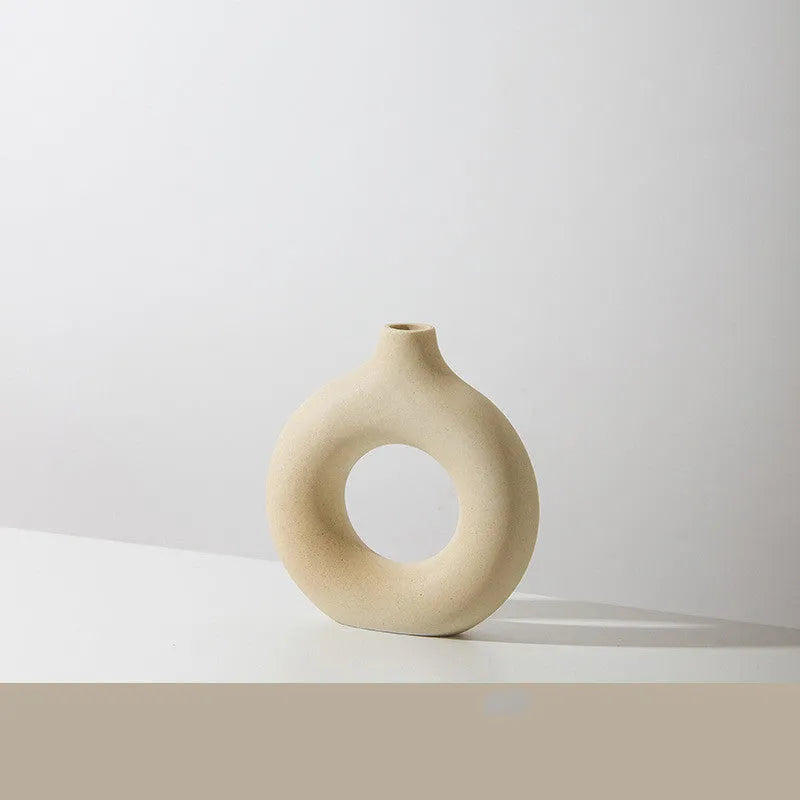 Frosted unglazed porcelain biscuit vase in a simple modern style on a table.