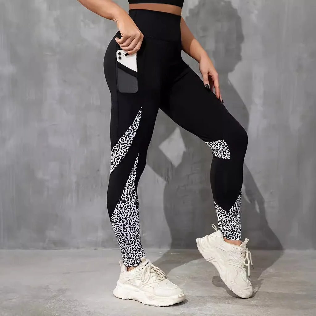 Black women's high-waist fitness leggings with colour-contrast patchwork patterns and side pockets.