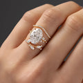 Copper zircon ring set with goose egg-shaped cut in Q681 gold on hand, three rings with flower and geometry shapes