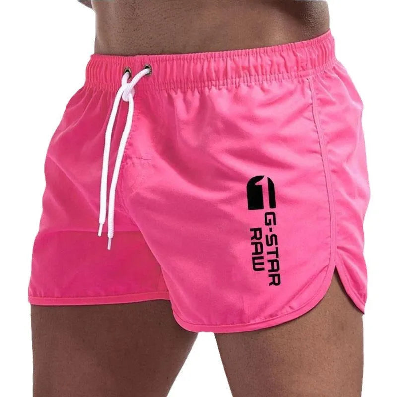 Man wearing thin polyester sports shorts with an elastic waistband in a bright colour like fluorescent green.