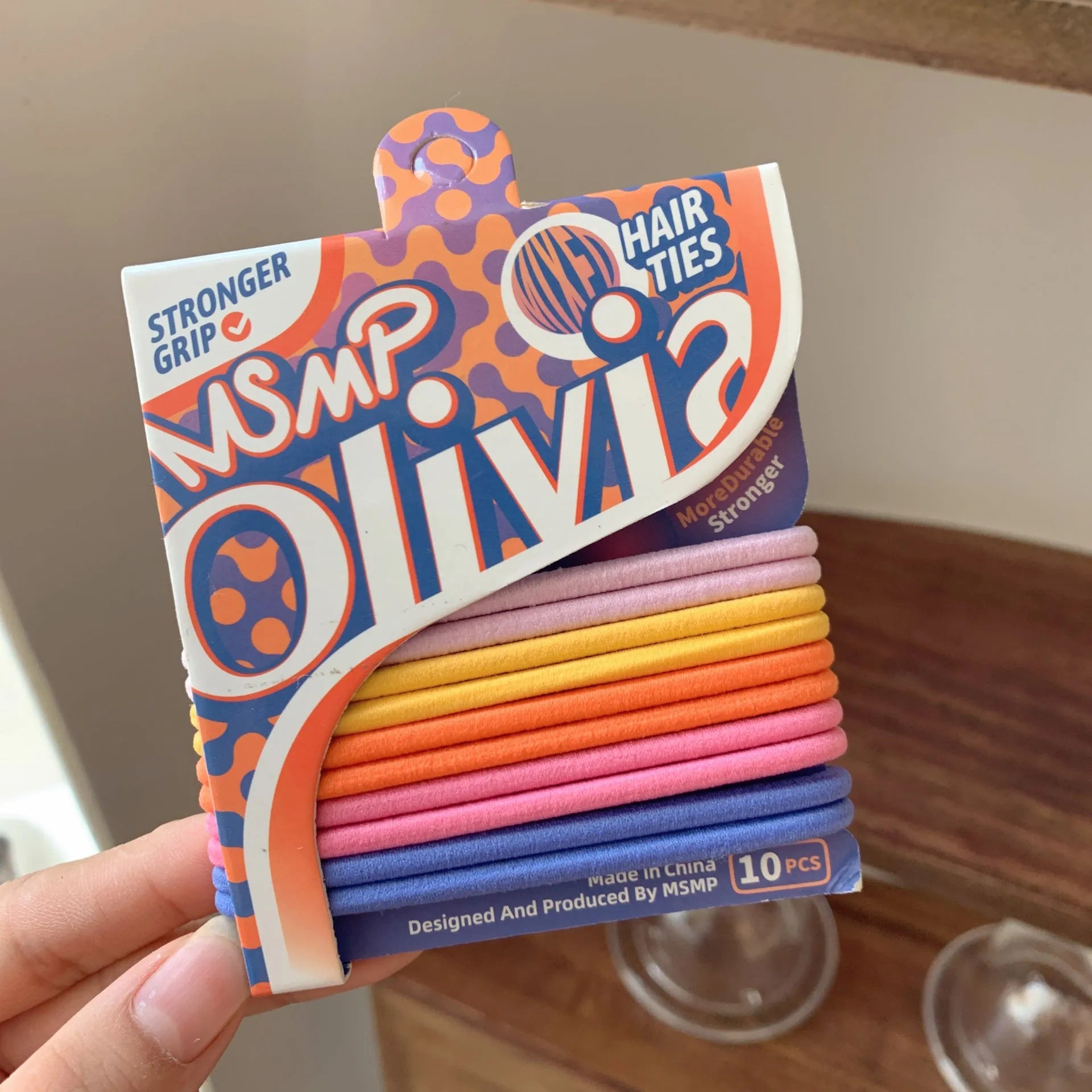 Candy colour elastic hair bands with braided design stretched to show length