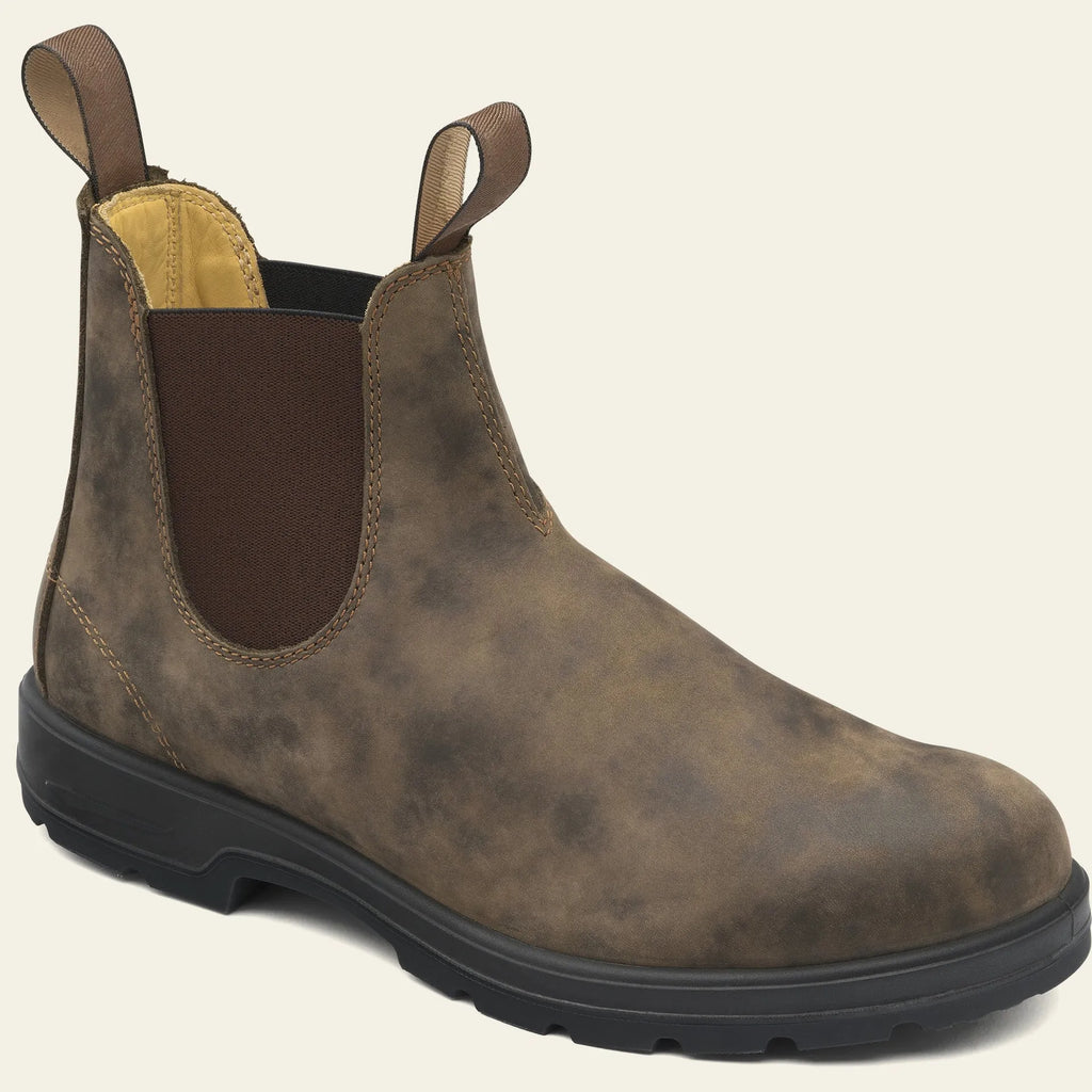 Vintage brown unisex Chelsea boots with frosted PU upper and car suture detailing on a wooden floor.