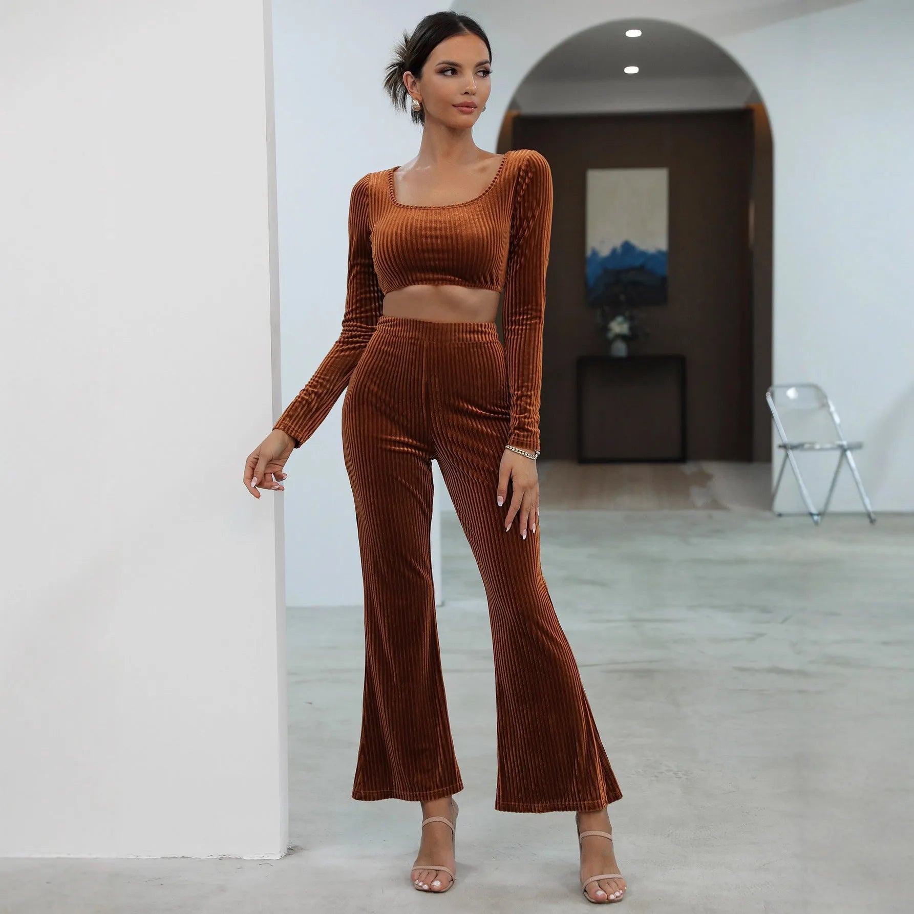 Caramel coloured long sleeve sweater and matching trousers set on a hanger.