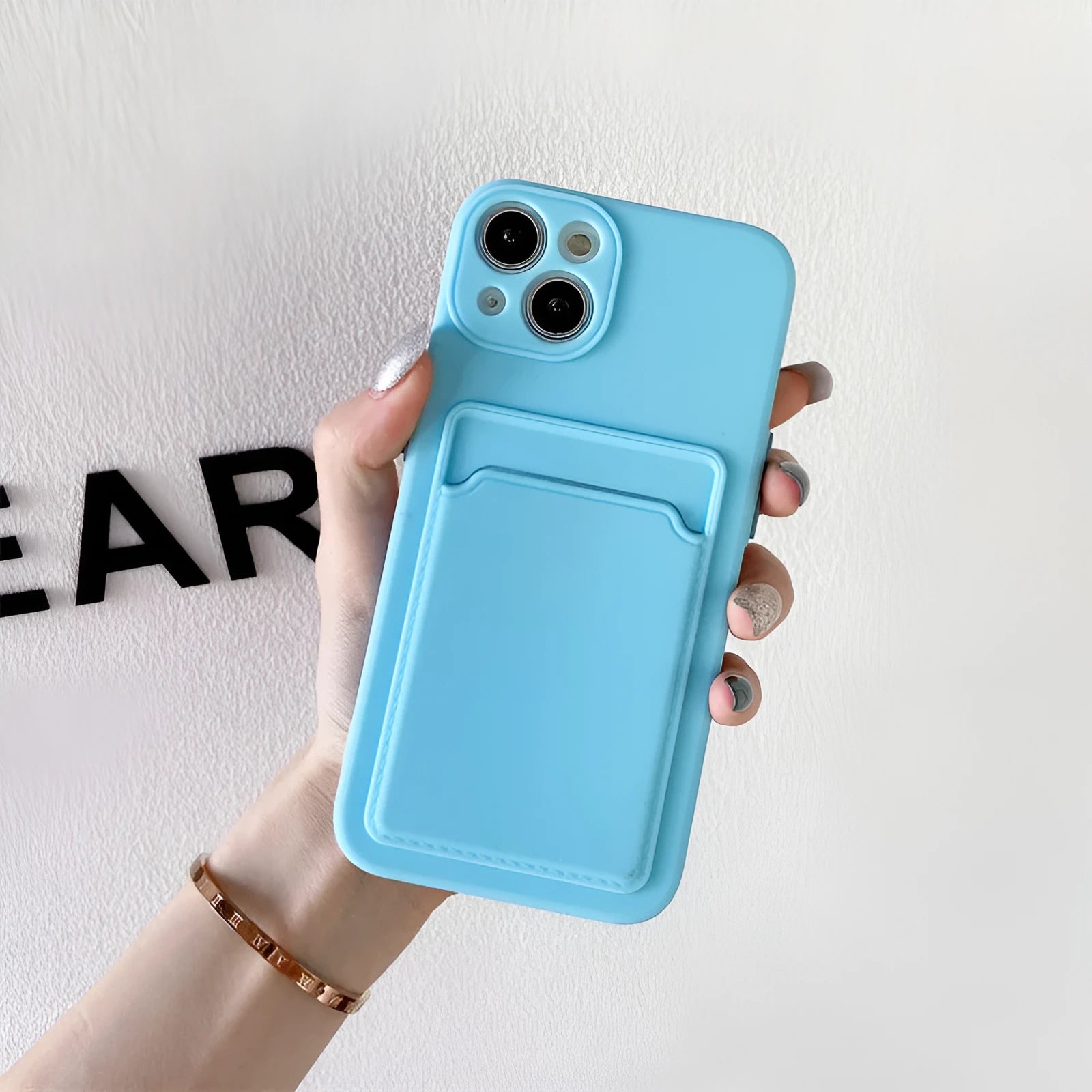 Sky blue colour block silicone iPhone case with a visible card slot on the back.