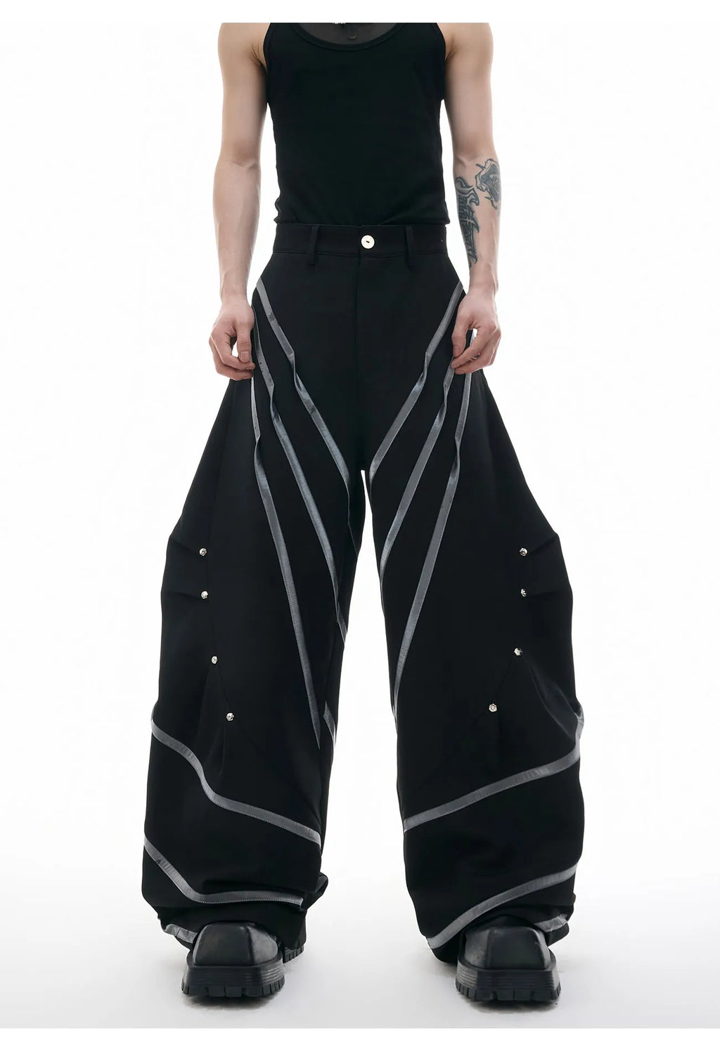 Men's black trousers with metal striped rivet and pleated detail on a three-dimensional cut.