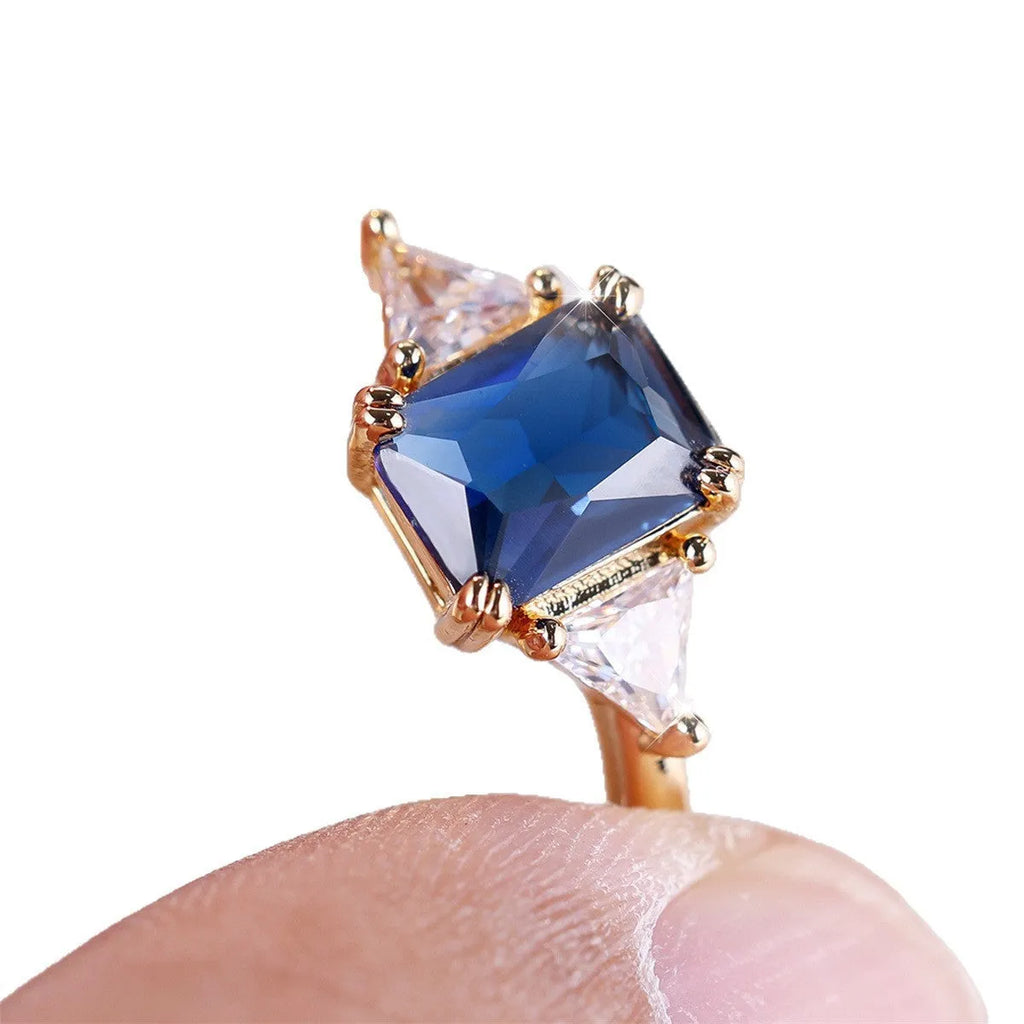 Copper rectangular fashion ring for women in gold sapphire blue colour