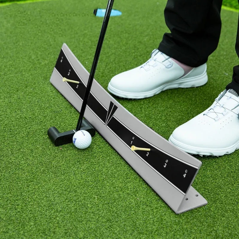 Golf putter with attached adjustable balance simulator showing the extended push rod mechanism on a putting mat.