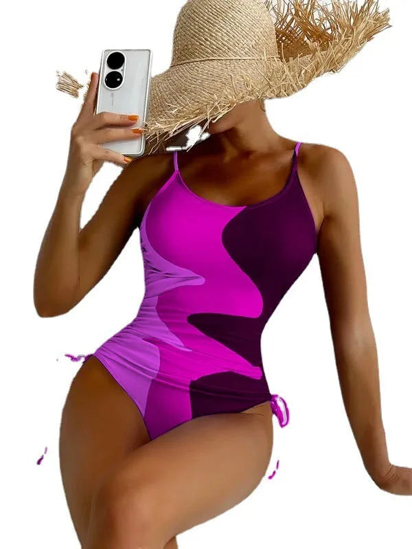 Women's sleeveless backless one-piece swimsuit in blue, purple, brown, or green.