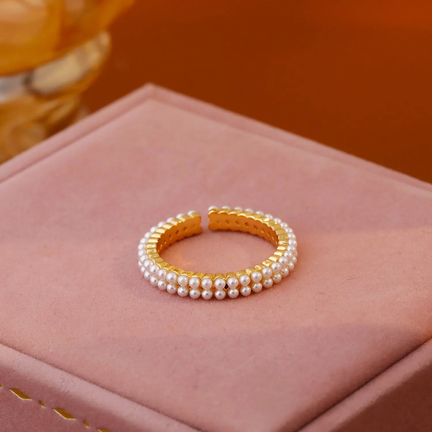 Geometric gold electroplated women's ring with open mouth design and round pearl element