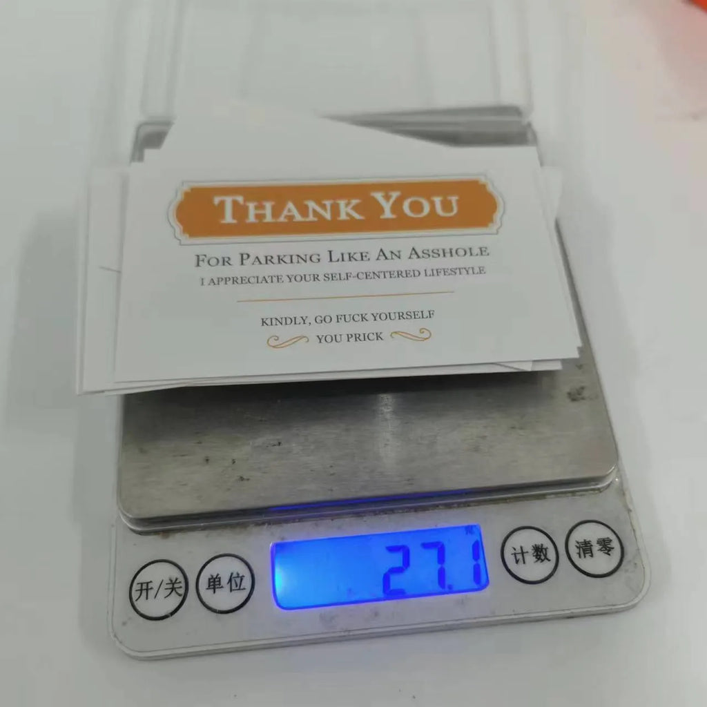 Box of paper illegal parking reminder cards featuring a printed middle finger design.