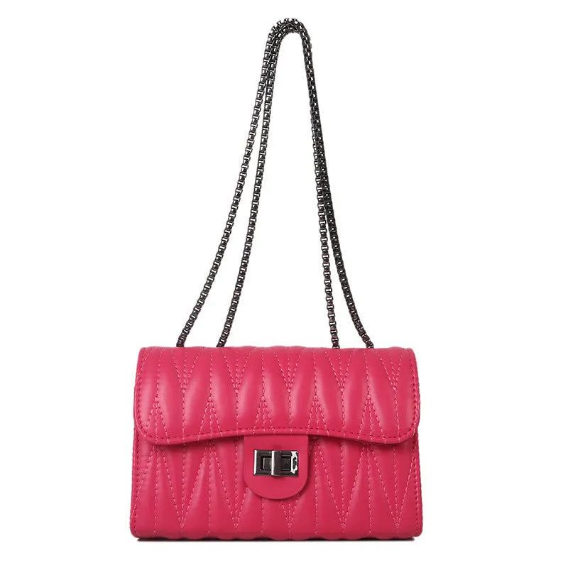 Small beige retro diamond texture PU women's bag with a shoulder strap on a table.