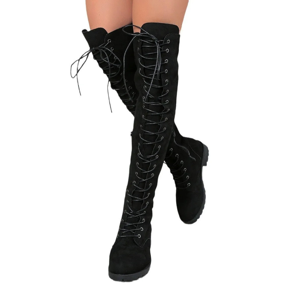 Black lace-up over-the-knee boots with a round toe, flat rubber sole, and decorative stitching on the shaft.