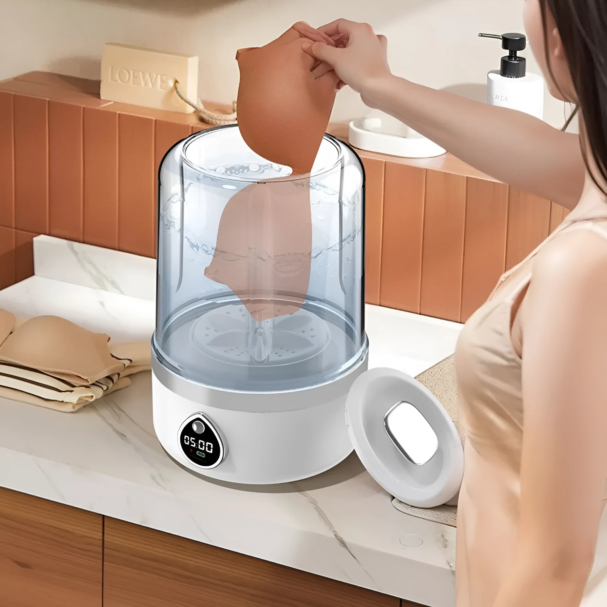 White portable USB-powered mini washing machine on a countertop.