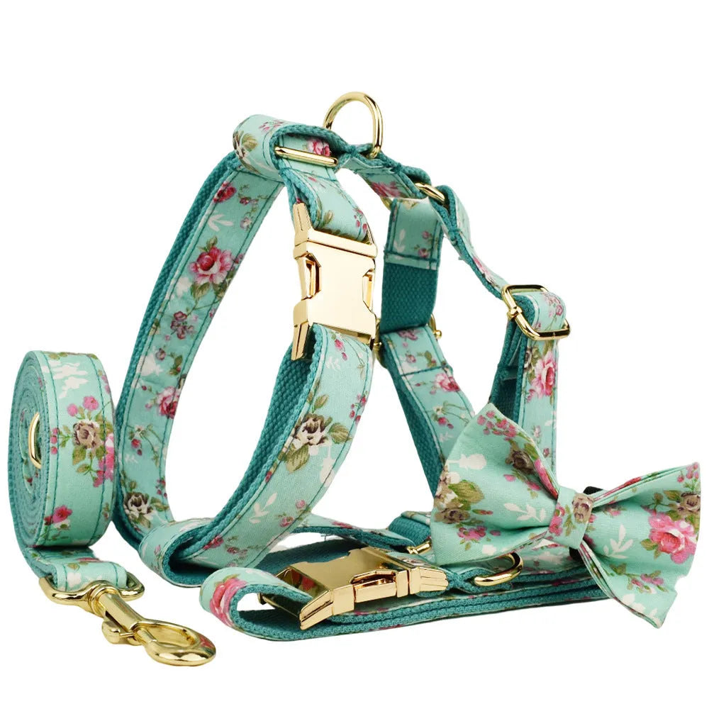 Rose-coloured fabric dog collar set with green background, includes leash, detachable bow, and vest for dogs.