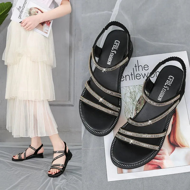 Women's flat casual sandals with rhinestone decoration on a PU upper and a rubber sole, in gold colour.