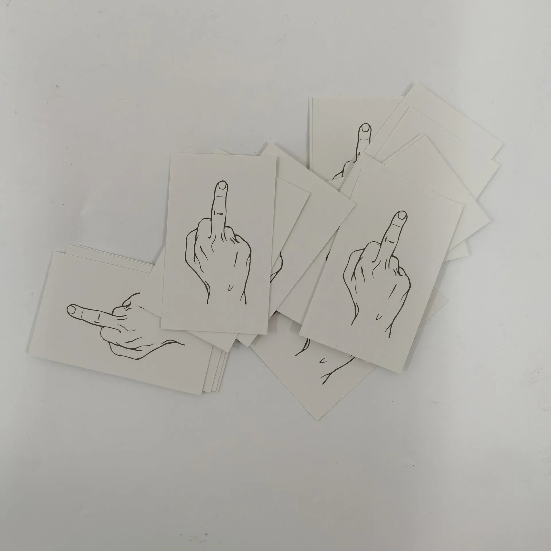 Box of paper illegal parking reminder cards featuring a printed middle finger design.