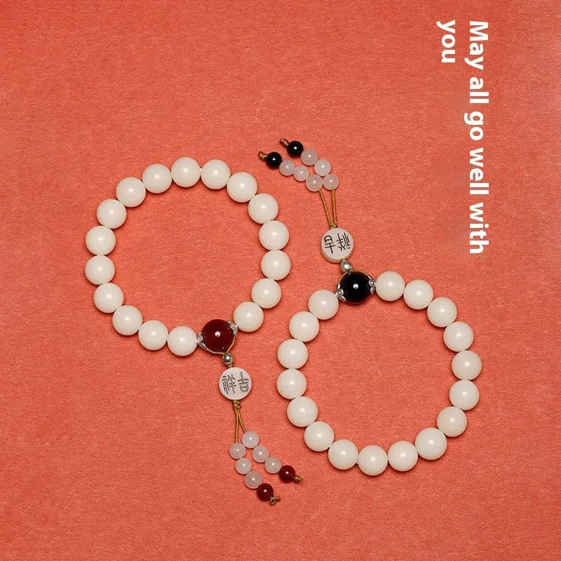 White jade bodhi bracelet with 10mm round seeds and traditional ruyi charm accents
