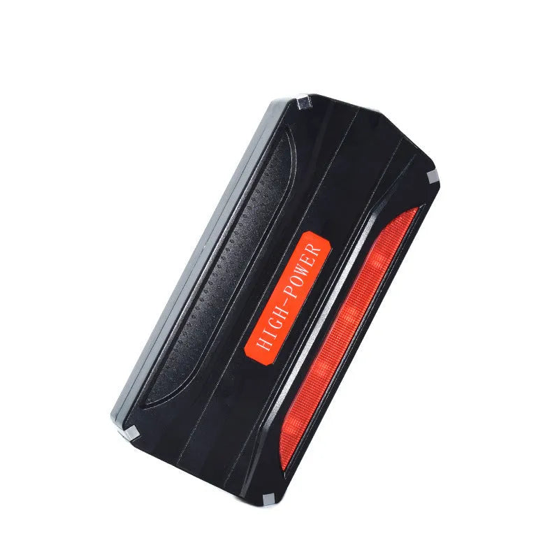 Black and red portable vehicle jump starter power bank with battery clamps.