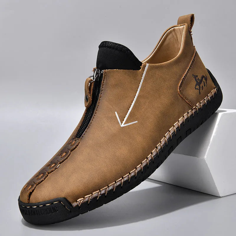 Men's black leather martin boots with a front zipper and round toe on a rubber sole.