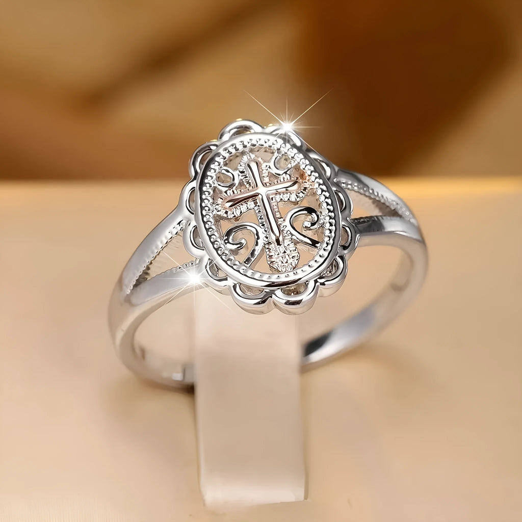 Women's silver cross lace fashion ring with detailed pattern, shown on a finger.