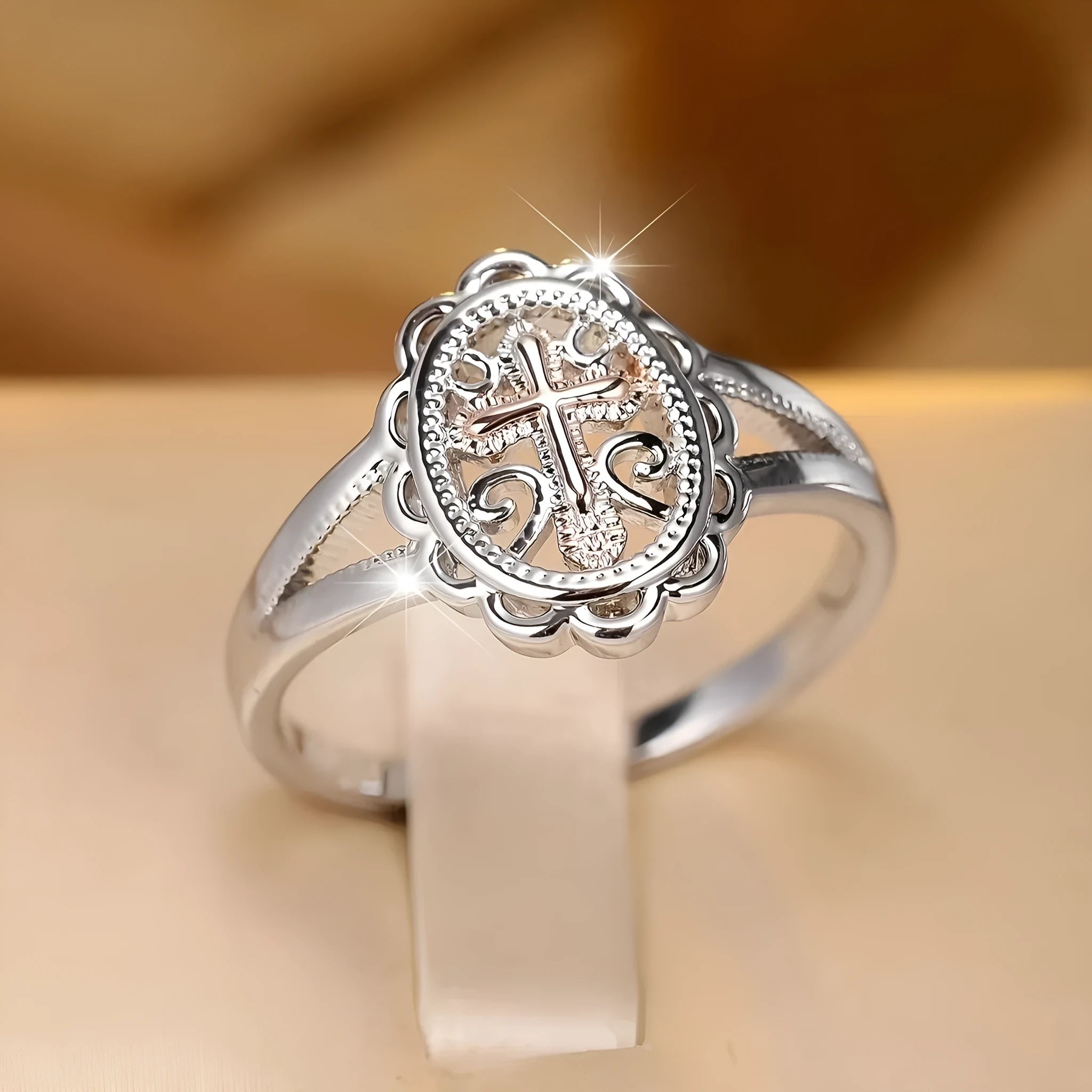 Women's silver cross lace fashion ring with detailed pattern, shown on a finger.