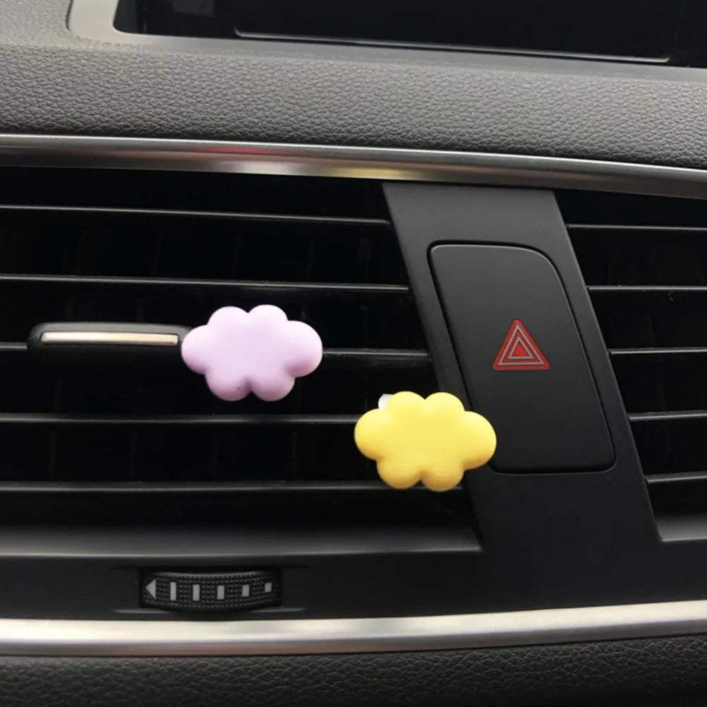 Colourful resin cartoon cloud car air freshener clip on a car vent.