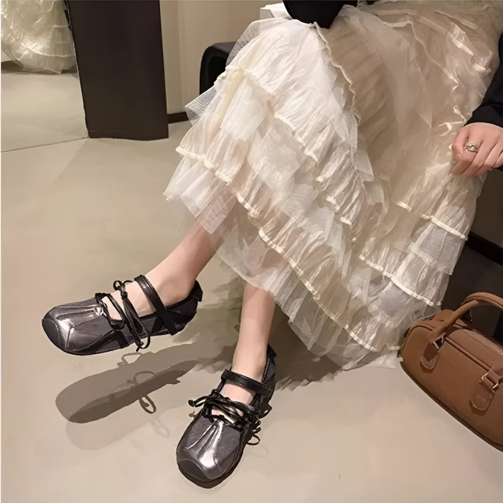 Beige vintage Mary Jane ballet flats with a round toe, lace-up front, and a mid-height English muffin heel.