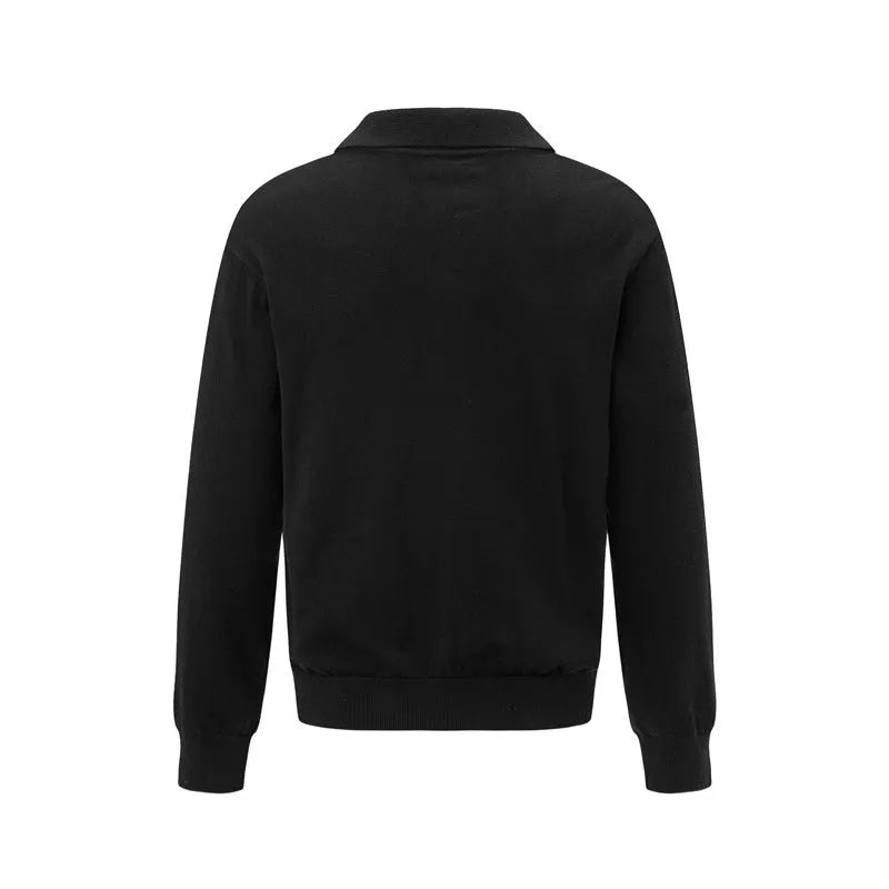 Man wearing a loose black pullover sweater for casual leisure wear.