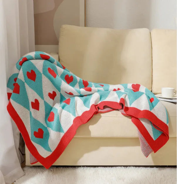 Bohemian style acrylic sofa cover blanket with tassel trim in a geometric pattern colour option.
