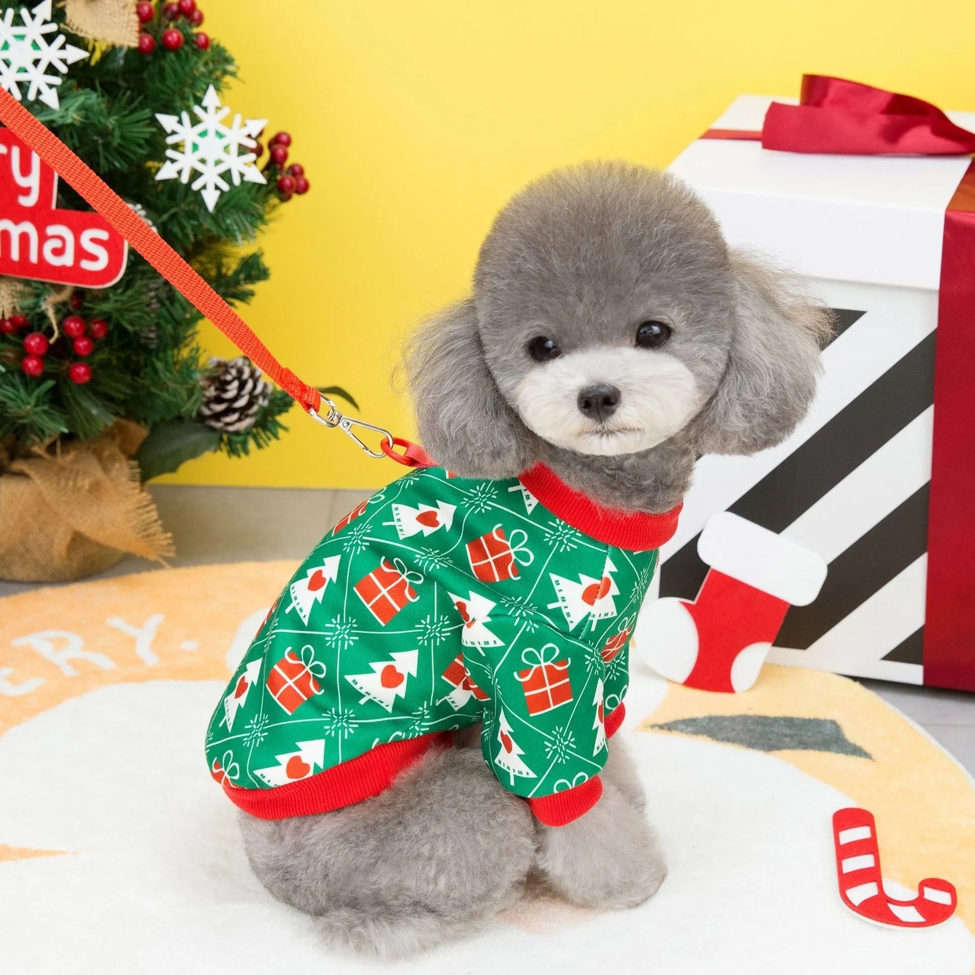 Green dog Christmas jumper with festive tree design, showing hoodie style and polyester fabric texture
