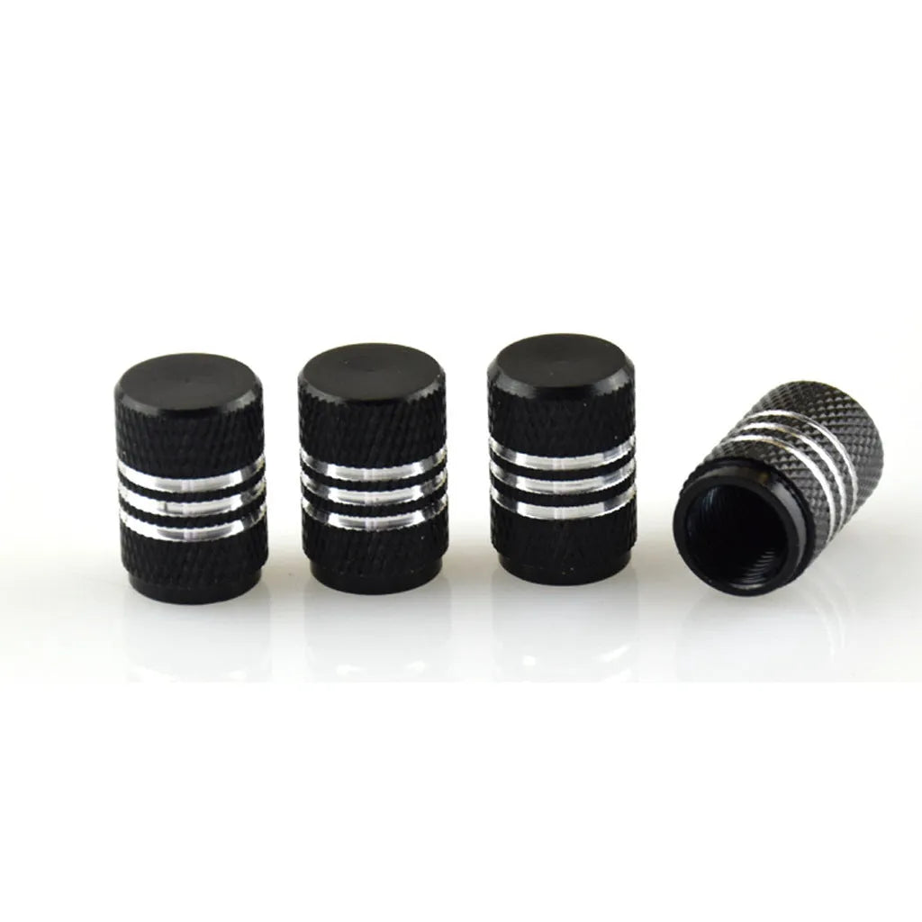 Set of aluminium alloy tyre valve caps in various metallic colours including red, blue, black, gold and silver.