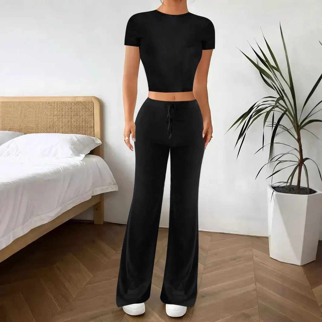 Black women's polyester trousers suit with high-waist trousers and a short-sleeve T-shirt on a hanger.
