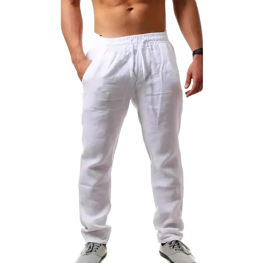 Men's loose-fitting cotton beach trousers in a solid colour, shown in a casual setting.